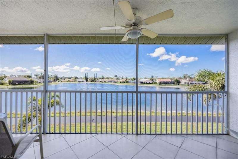 Unfurnished sunroom with a water view and ceiling fan