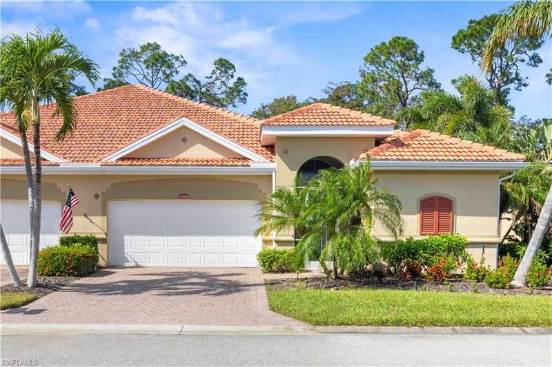 Attached villa, stucco exterior, private pool, attached garage, decorative driveway, and a tile roof.