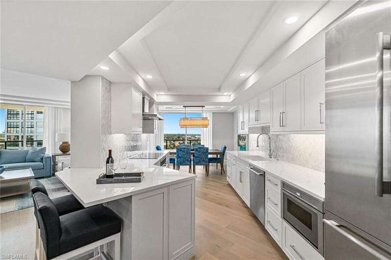 Kitchen with Thermador appliance package with stainless steel finishes, tasteful backsplash, light quartz counters, and recessed lighting