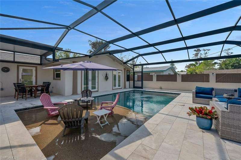 Swimming pool featuring a covered patio and picture frame lanai