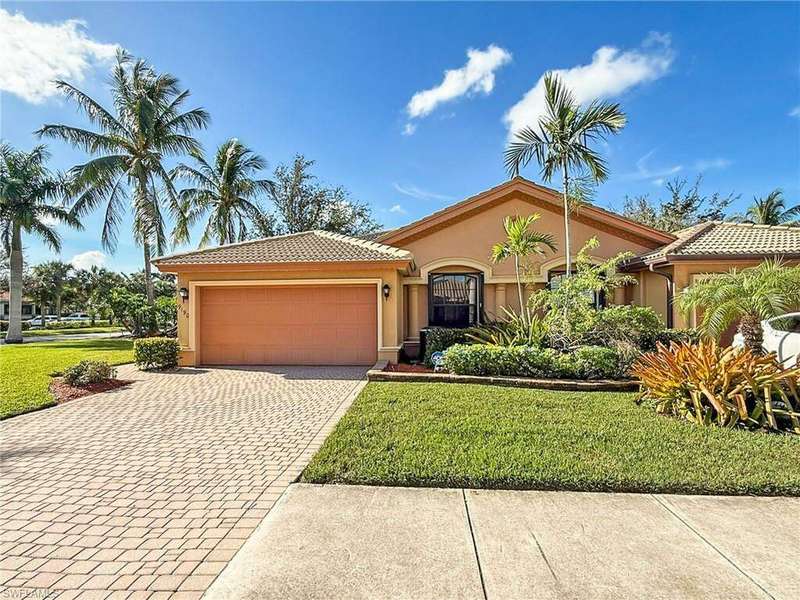 Mediterranean / spanish home with a front yard and a garage