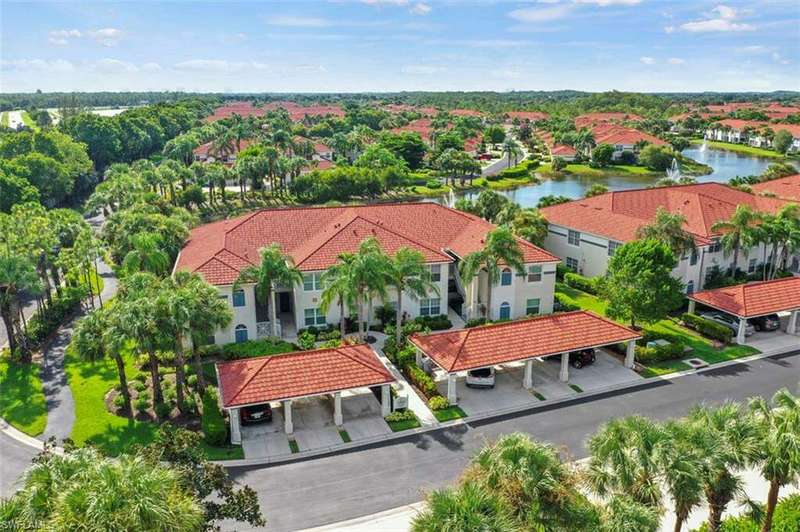 Birds eye view of property with a water view