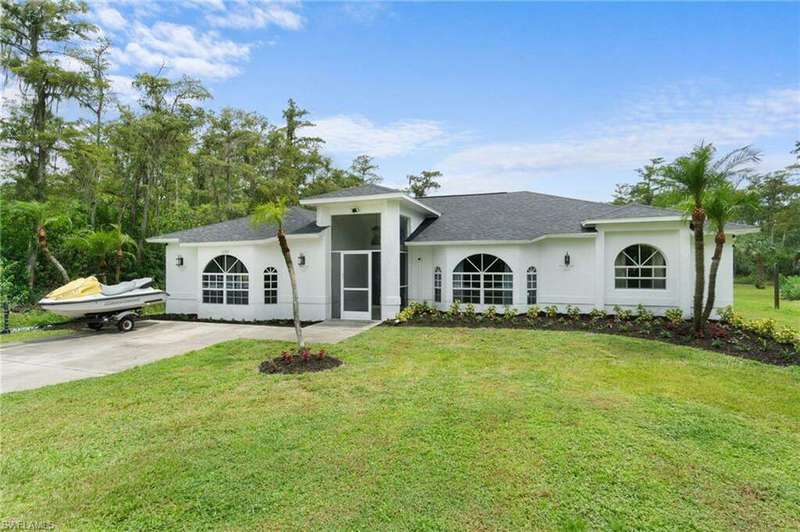 Ranch-style house featuring a front yard with extra parking