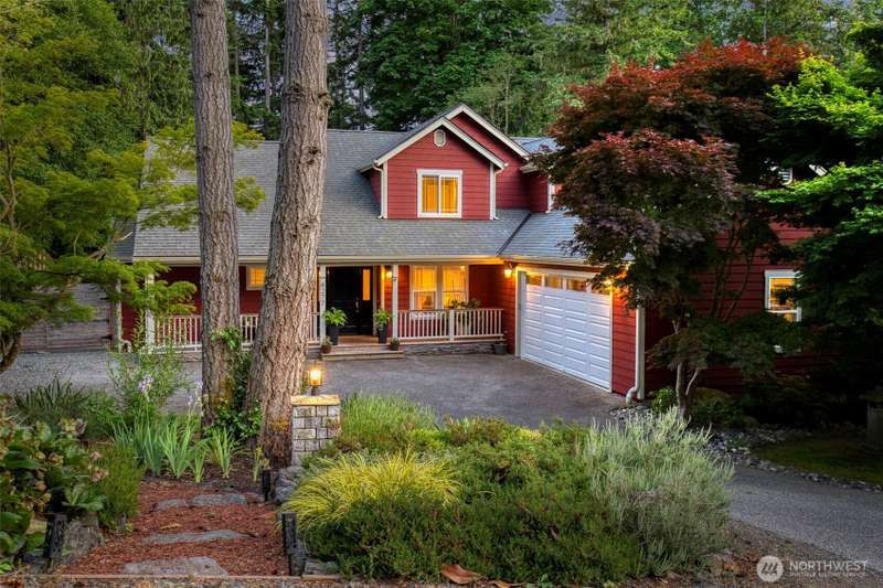 Charming Bainbridge Island home nestled among mature trees, offering privacy and a warm welcome from the moment you arrive.
