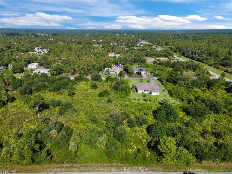 Aerial view of property's location featuring a forest