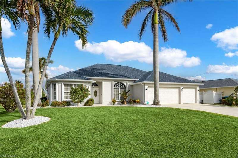 Ranch-style home featuring a garage and a front yard