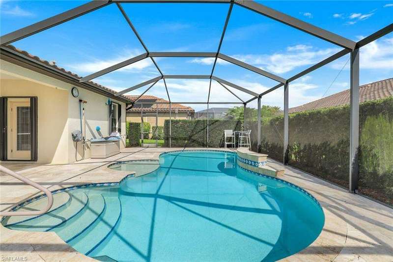 View of swimming pool featuring a lanai and a patio