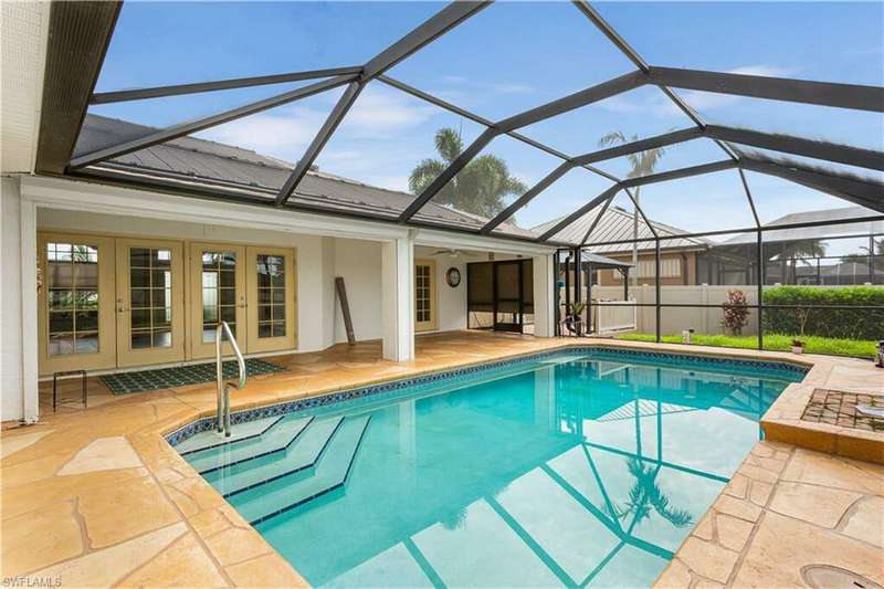 View of swimming pool with a patio area and a lanai