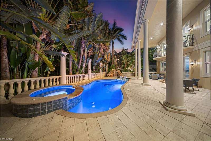View of swimming pool with outdoor dining space, a pool with connected hot tub, and a patio area