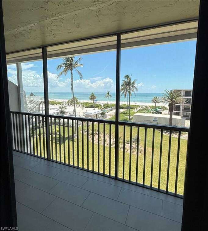 Dining & Living area virtually staged, impact sliders, tiled lanai, wood look tile throughout, crown molding, unfurnished condo.