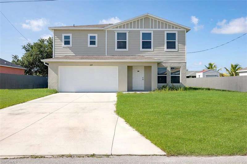 View of front of house with a garage, driveway, stucco siding, and roof with shingles.