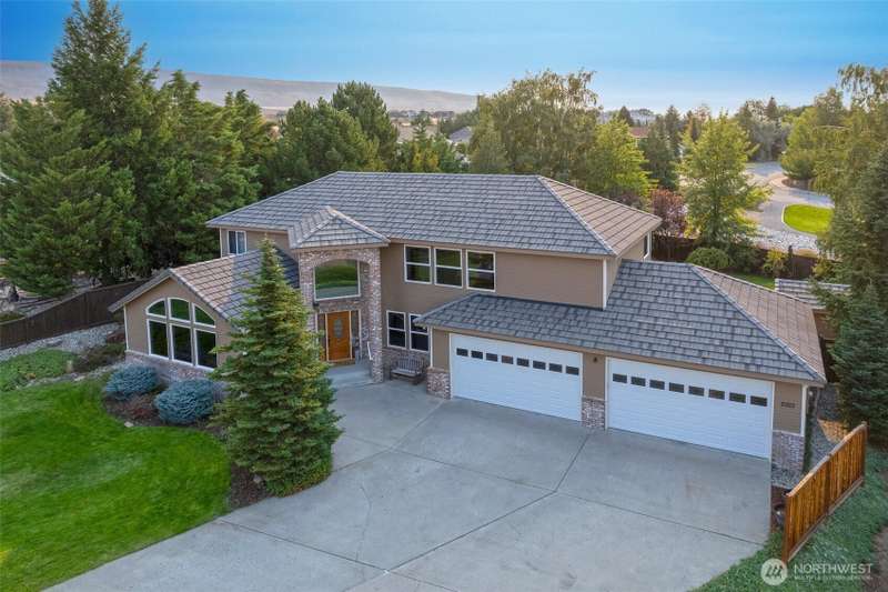 Front of Home with a 4 car garage.