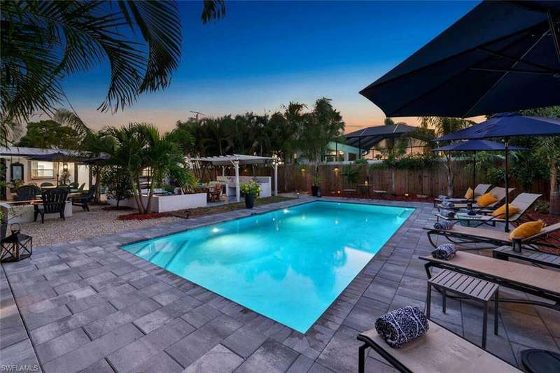 Pool at dusk featuring a patio area