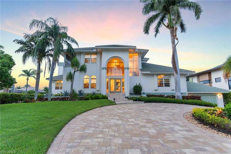 Mediterranean / spanish-style house featuring a garage and a yard