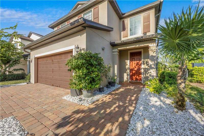 View of front of house with stucco siding, an attached garage, and decorative driveway