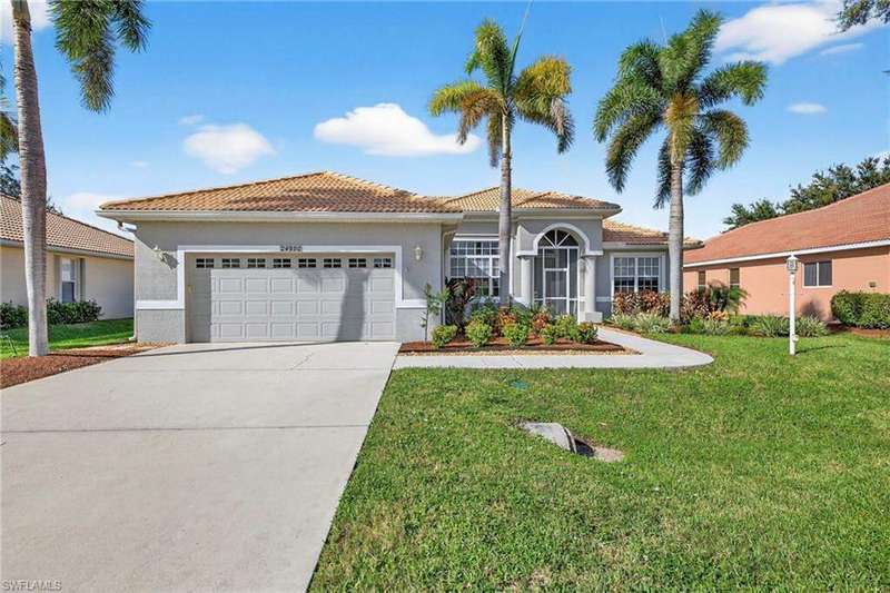 Mediterranean / spanish-style home with a front lawn, stucco siding