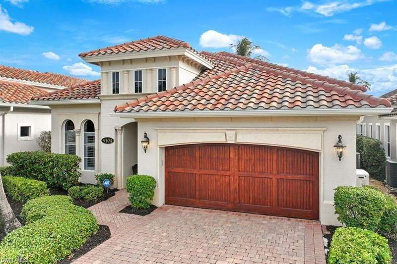 Mediterranean / spanish-style house featuring a tile roof, stucco siding, decorative driveway, and a garage