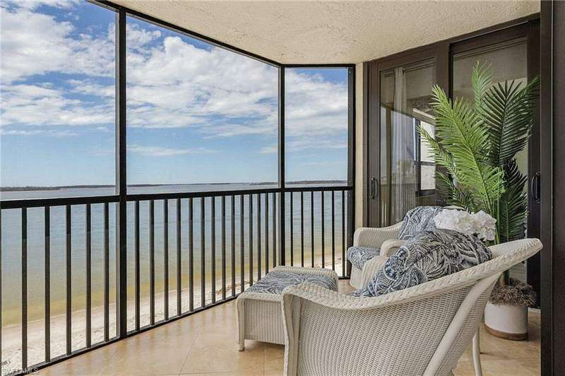 Sunroom / solarium with a water view