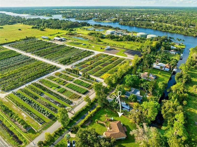 Birds eye view of property featuring a water view and a rural view