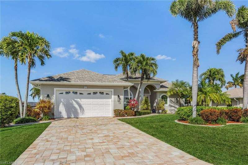 Ranch-style home featuring a front yard and a garage